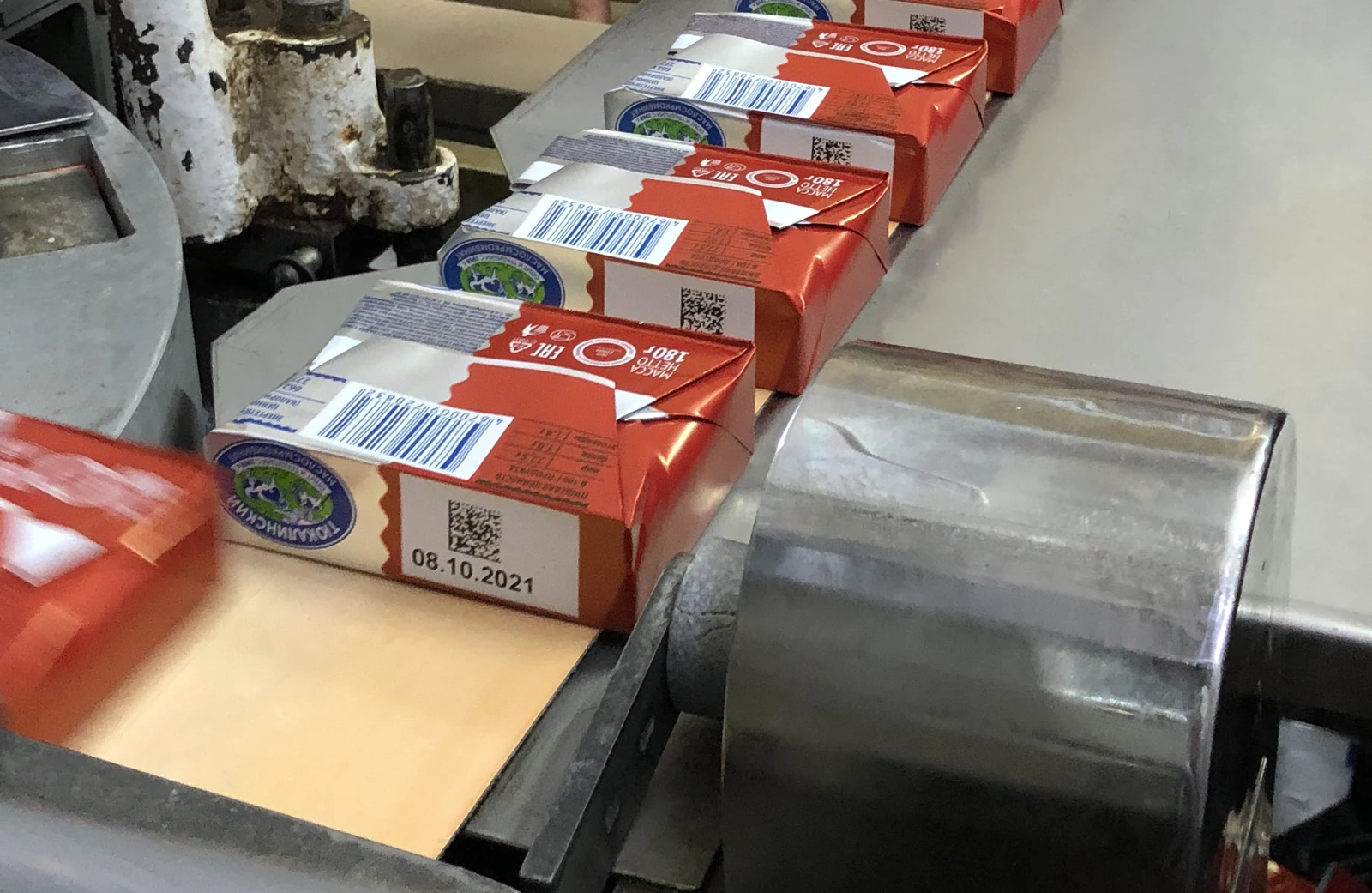 Butter packs on the line, each printed with a code and date